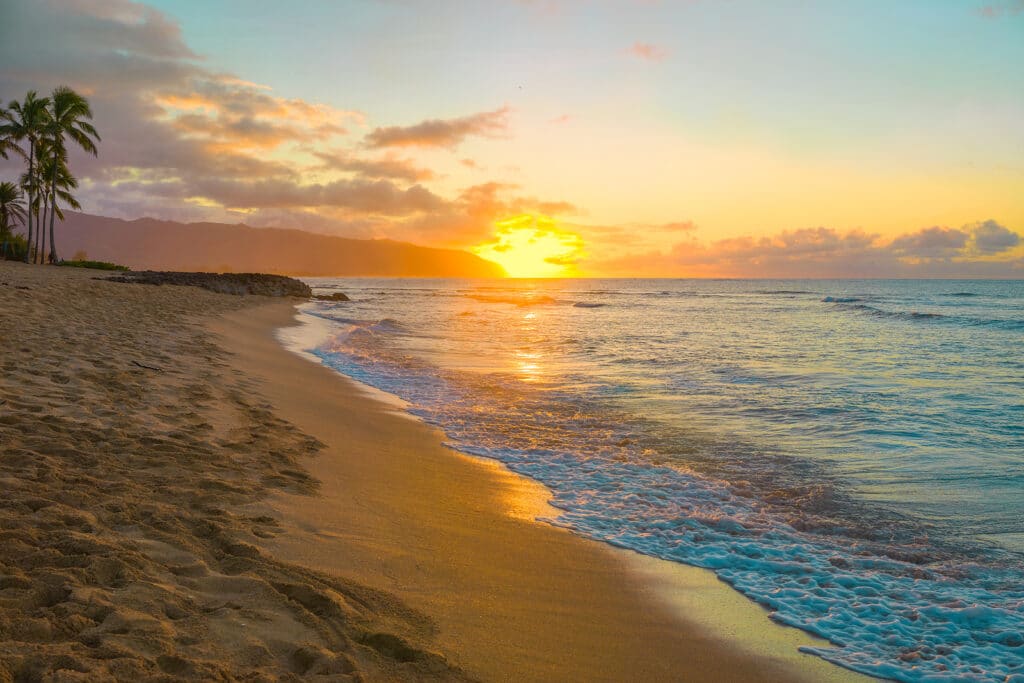 Beautiful colorful tropical Hawaiian sunset or sunrise on beach in Haleiwa, Oahu